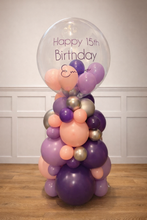 Load image into Gallery viewer, Balloon arrangement with a clear bubble containing 'Happy 15th Birthday Emma' text on a wooden floor.