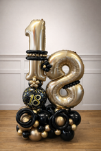 Load image into Gallery viewer, Gold, black, and silver balloon arrangement with number '18' on a wooden floor.