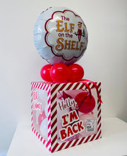 Load image into Gallery viewer, Decorative balloon and box set with 'Elf on the Shelf' theme on a white surface.