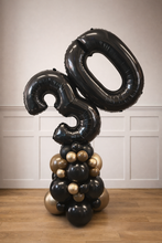 Load image into Gallery viewer, Black and gold balloon sculpture with number '30' against a white paneled wall.
