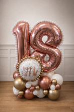 Load image into Gallery viewer, Rose gold number '18' balloons with a 'Happy Birthday' balloon on a wooden floor.