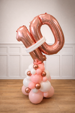 Load image into Gallery viewer, Rose gold and pink balloon sculpture with number '40' on a wooden floor.
