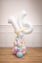 Load image into Gallery viewer, Balloon sculpture with pastel balloons and a large white letter 'Y' on a wooden floor.
