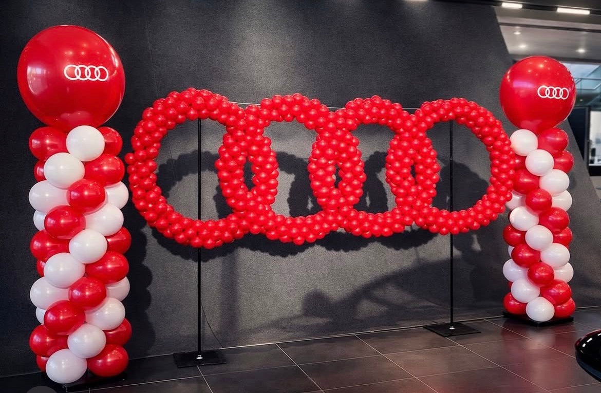 Audi logo made of balloons in a showroom setting