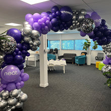 Load image into Gallery viewer, A balloon arch featuring a mix of purple, silver, and black balloons with added disco ball balloons, set up indoors, likely for a celebration or event.
