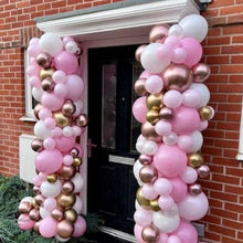 Load image into Gallery viewer, A balloon column featuring a mix of pink and gold balloons tied to a doorway, with a full-length organic design without a topper balloon.
