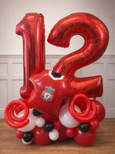 Load image into Gallery viewer, Red balloon sculpture with number 12 and sports team of Liverpool logo on a wooden floor.
