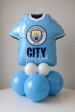 Load image into Gallery viewer, Balloon sculpture of a Manchester City football jersey with white text on a plain background
