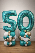 Load image into Gallery viewer, Turquoise '50' balloon stacks with smaller balloons below on a wooden floor.
