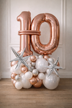 Load image into Gallery viewer, Rose gold '10' balloon and decorative balloons on a wooden floor with a neutral wall background
