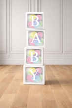 Load image into Gallery viewer, Stack of white blocks with colorful letters spelling 'BABY' on a wooden floor.
