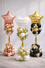 Load image into Gallery viewer, Three balloon arrangements with personalized messages on a wooden floor.
