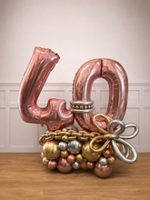 Load image into Gallery viewer, Decorative balloon arrangement with number '40' and decorative elements on a wooden floor.
