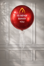 Load image into Gallery viewer, Red balloon with text and logo against a light gray paneled wall
